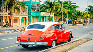 Red American car on Cuban street